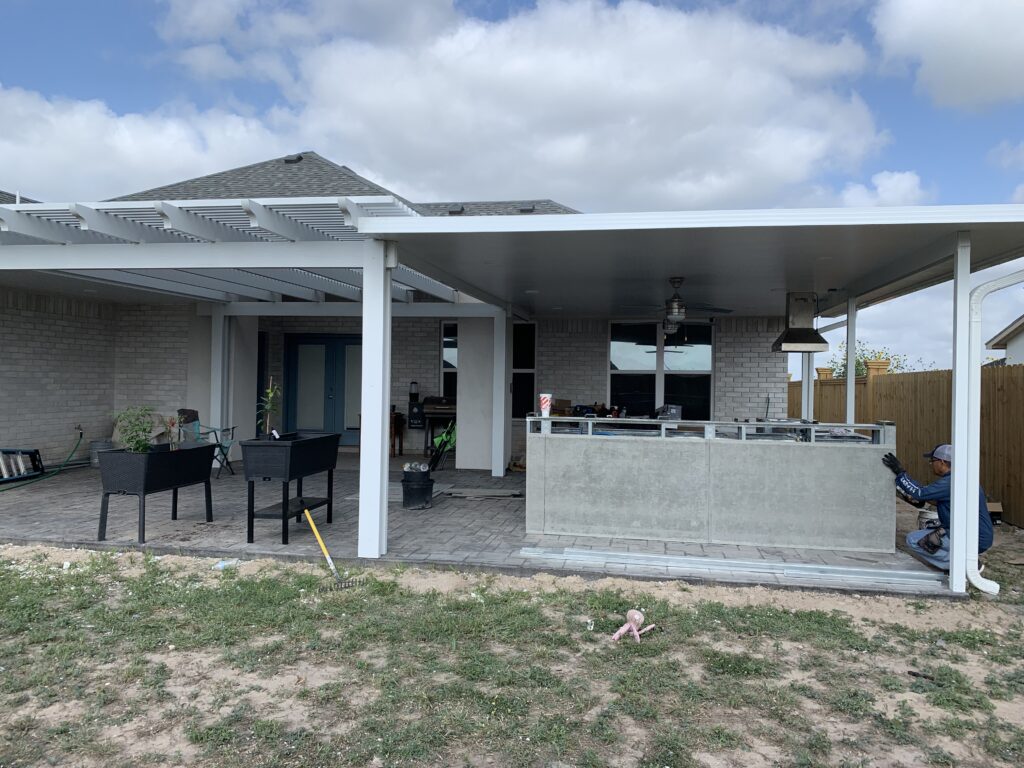 Outdoor kitchen with a bar top and stone base in The Woodlands, TX