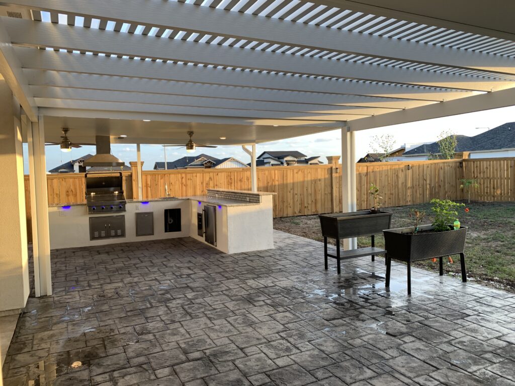 Custom outdoor kitchen with a built-in grill in a Houston, TX backyard