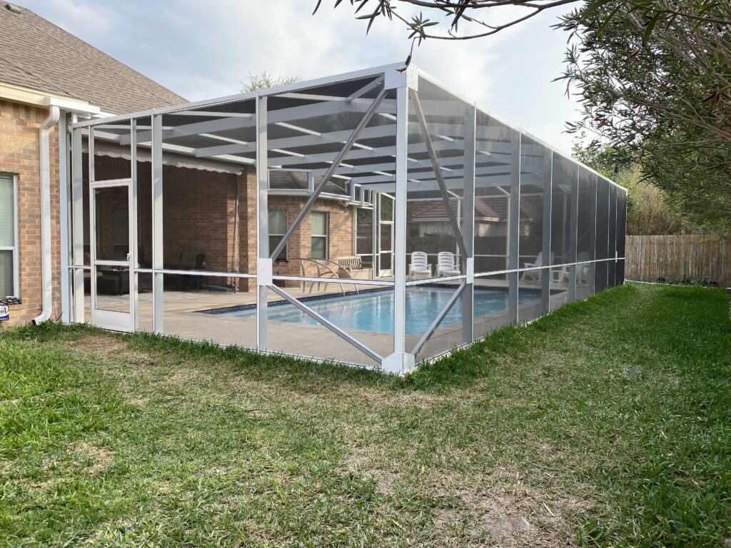 Custom screened pool enclosure over a backyard swimming pool