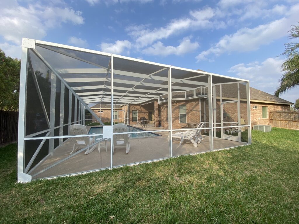 Custom screened pool enclosure over a backyard swimming pool